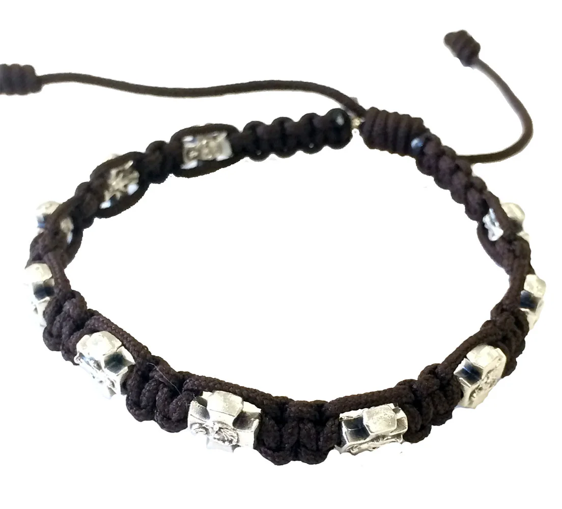 Bracelet with crosses. Metal and cord. Cord closure.